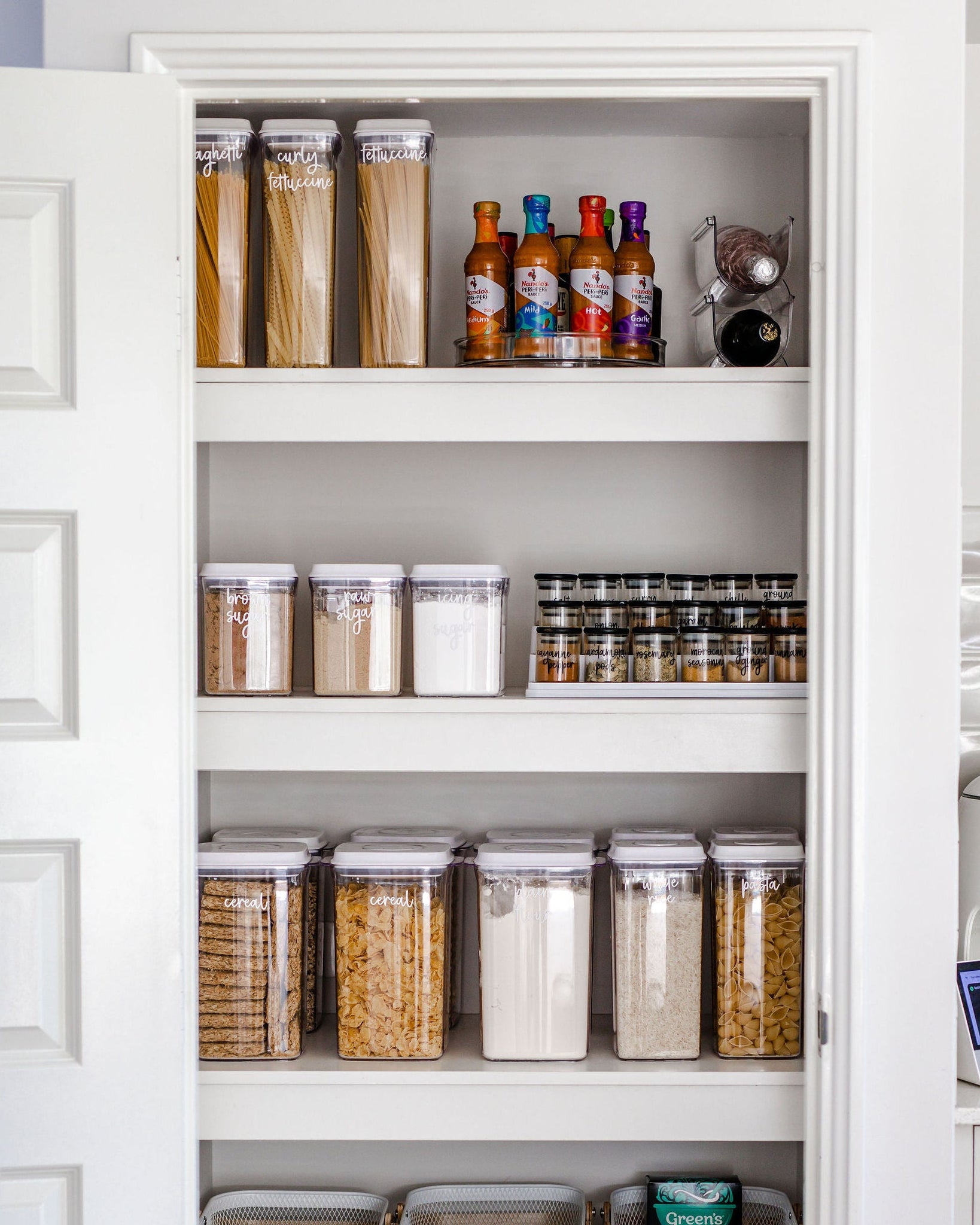 Organised pantry with various food items and pantry storage containers.