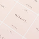Close-up view of pink, nude Luxe Minimalist sticker Labels with white text on clear labels, showing 'Cereal', 'Oats', and 'Rice