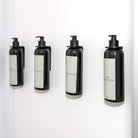 Acrylic Wall-Mounted Pump Bottle Holder in black and white, ideal for bathroom and caravan organisation.