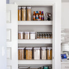 Organised pantry with various food items and pantry storage containers.