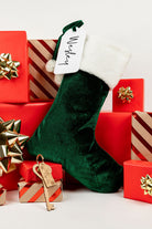 Children excitedly placing their personalised Santa stockings by the fireplace.
