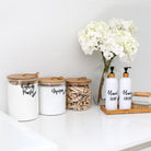 Eco-friendly storage jars made from bamboo and borosilicate glass.