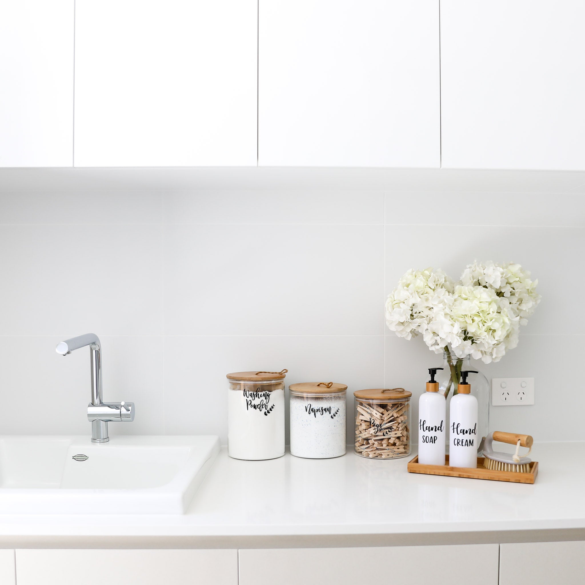 Versatile bamboo and glass jars used for storage in a stylish kitchen.