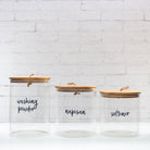 Custom labelled bamboo and glass storage jars for organised living.