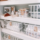 Large white storage baskets perfect for bulky linen items like towels and blankets.