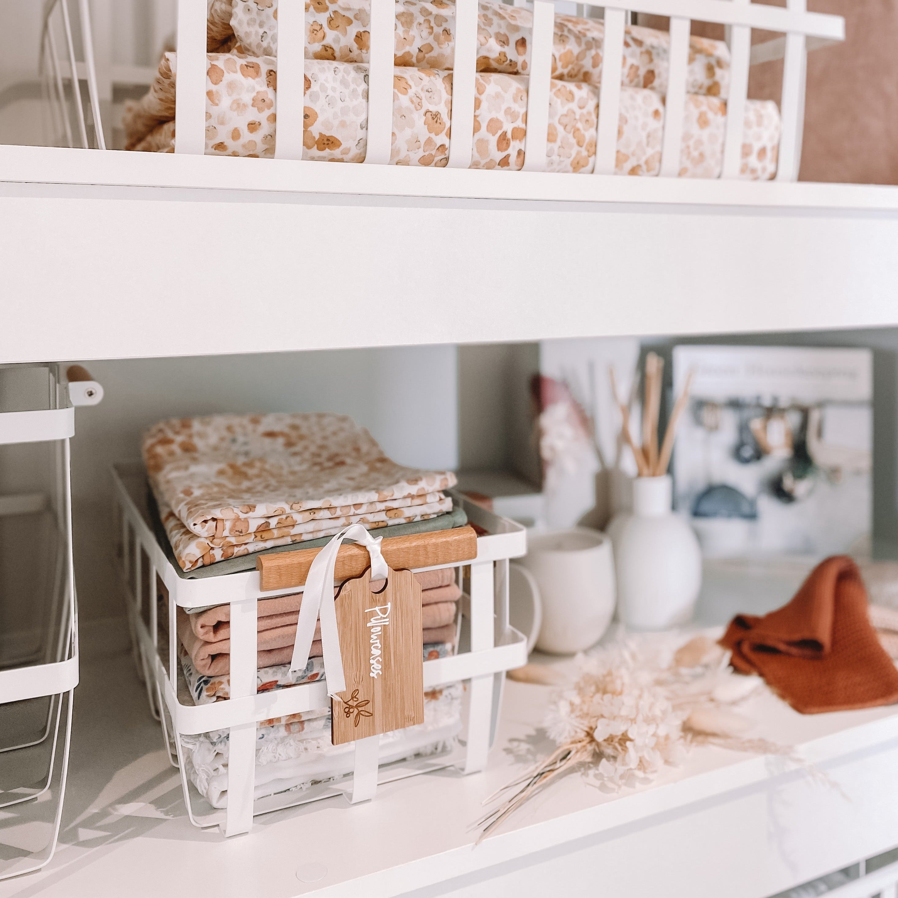 Stylish and durable white storage baskets for linen cupboard organisation.