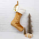 Family's personalised velvet Santa stockings arranged under the tree.