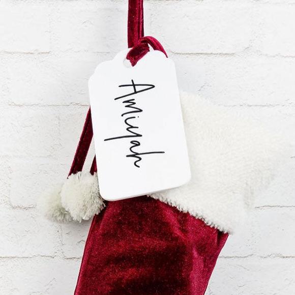 Classic red velvet Santa stocking with personalised acrylic tag.