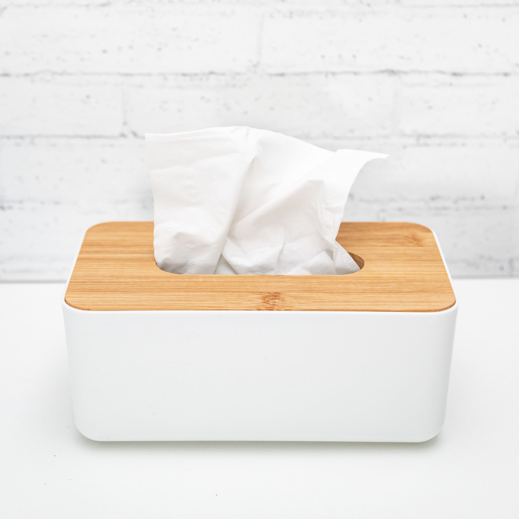 Tissue box with bamboo lid, stylishly designed for bathroom organisation.