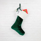 Velvet Santa stocking placed on a staircase, ready for Christmas surprises.