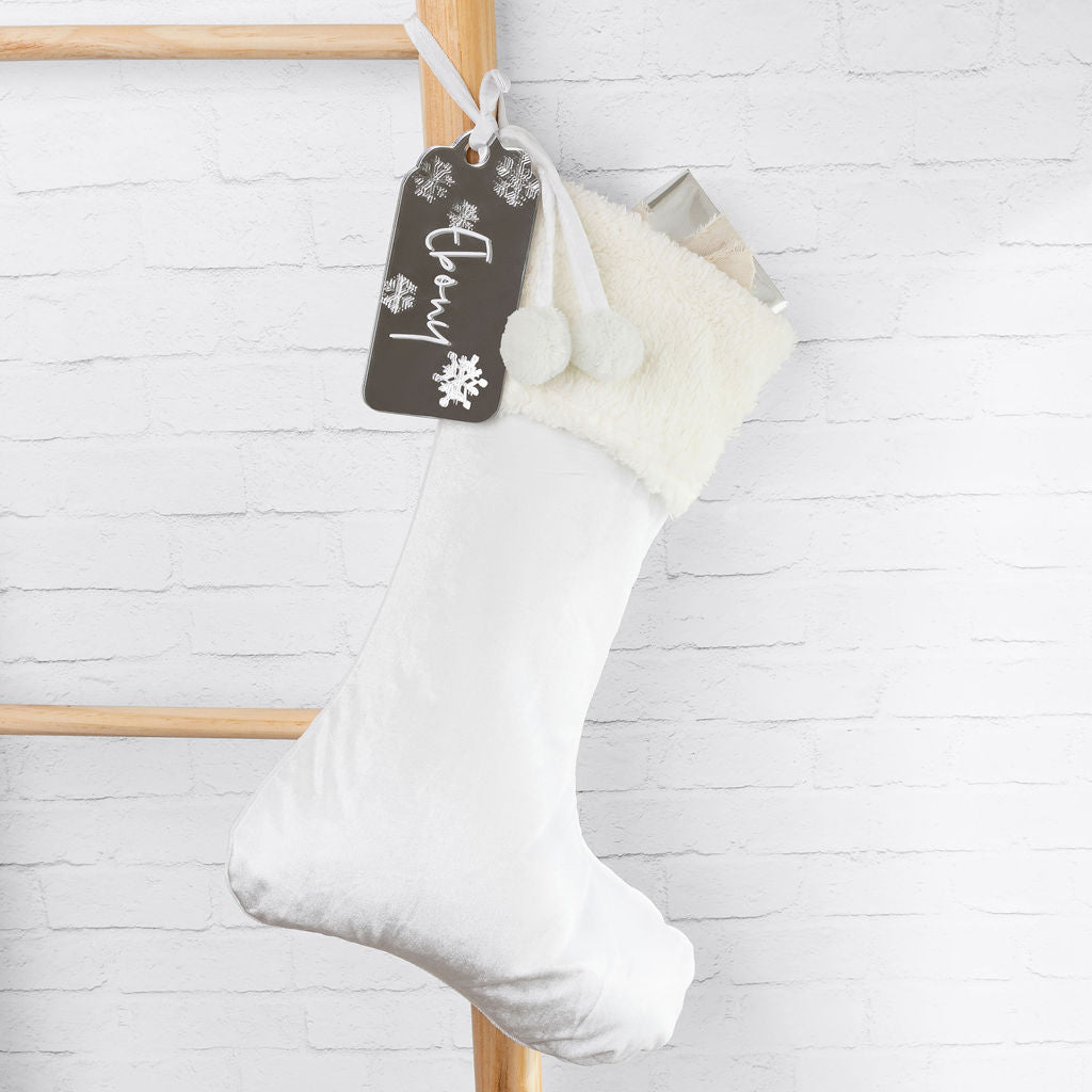 Plush white velvet Santa stocking showcasing the rich texture and personalised tag.